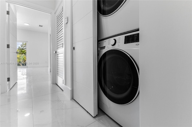 washroom featuring stacked washing maching and dryer