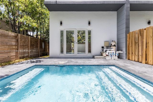 view of pool featuring french doors and a patio