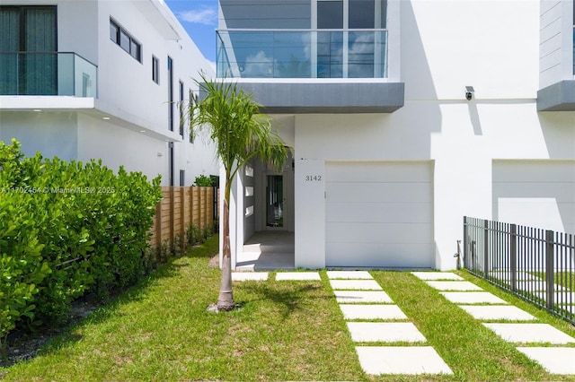 doorway to property featuring a yard