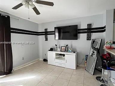 interior space with ceiling fan and light tile patterned flooring