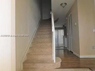 staircase with hardwood / wood-style floors