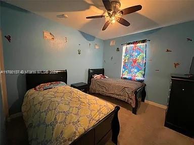 carpeted bedroom with ceiling fan