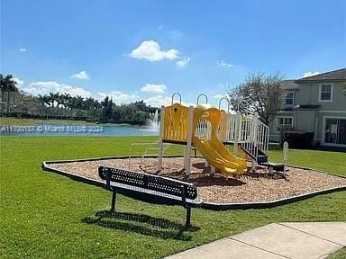 view of jungle gym featuring a yard and a water view