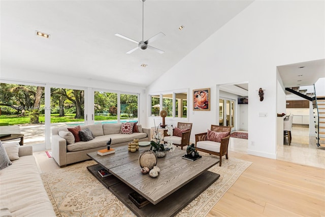 living room featuring french doors, light wood-type flooring, high vaulted ceiling, and ceiling fan