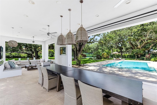 view of swimming pool featuring ceiling fan