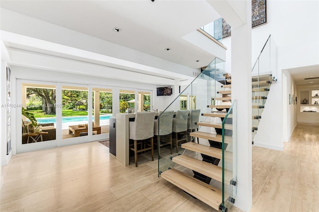 stairway with wood-type flooring and plenty of natural light