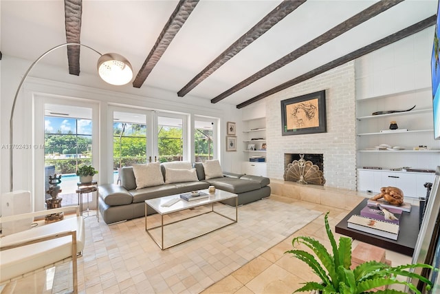 living room featuring built in shelves, vaulted ceiling with beams, light tile patterned floors, and a brick fireplace