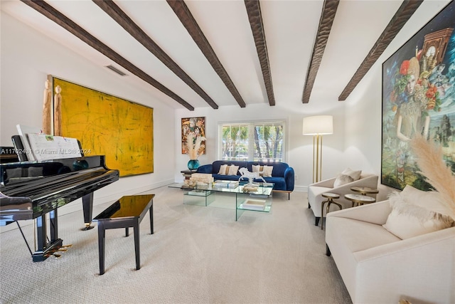 carpeted living room with beamed ceiling