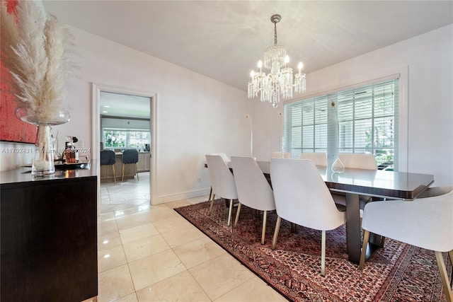 dining space with light tile patterned floors and a notable chandelier