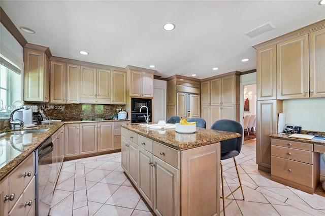 kitchen with dishwasher, sink, a kitchen breakfast bar, a center island with sink, and light tile patterned floors