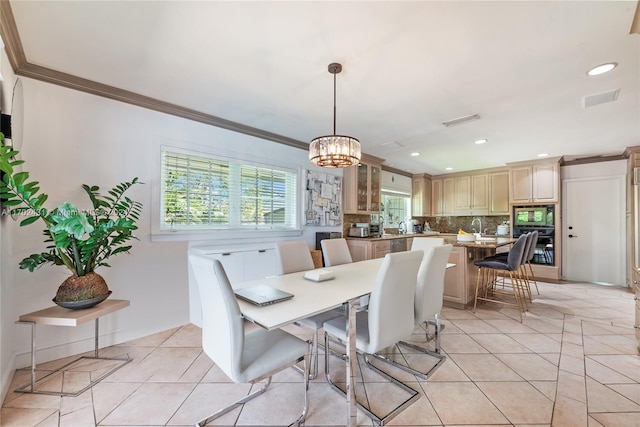 dining space with a notable chandelier, light tile patterned floors, and crown molding