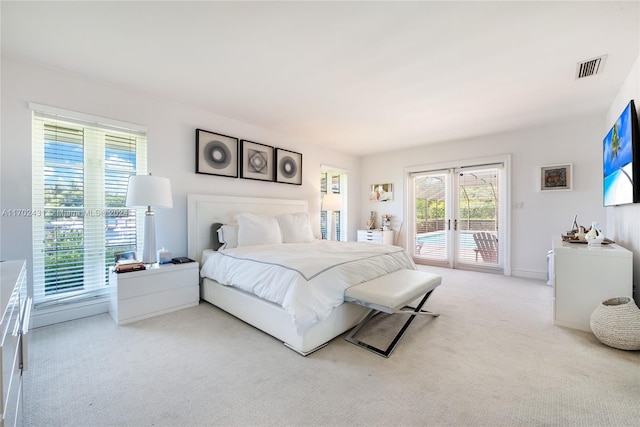 carpeted bedroom with access to outside and french doors