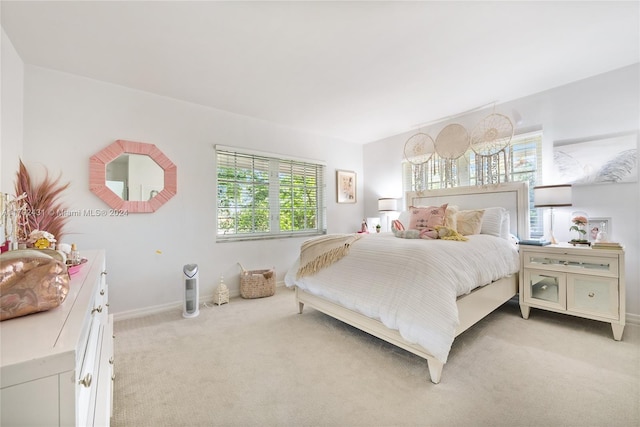 bedroom featuring multiple windows and light colored carpet