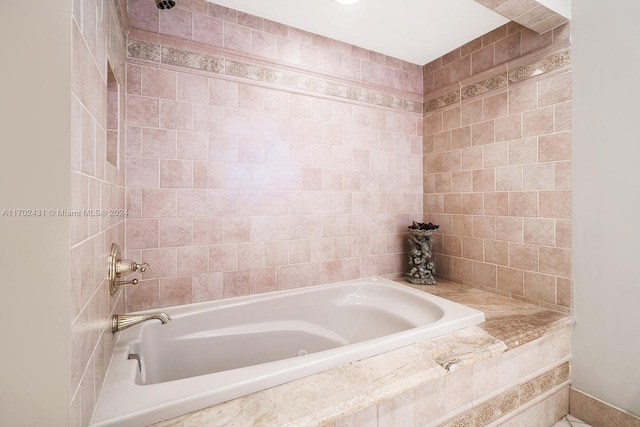 bathroom featuring tiled tub