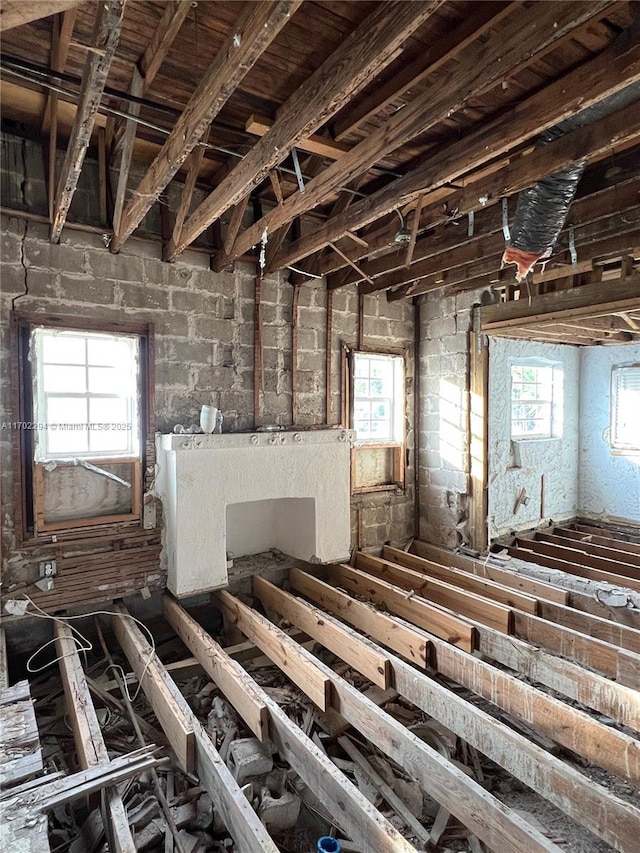 miscellaneous room featuring vaulted ceiling with beams and plenty of natural light