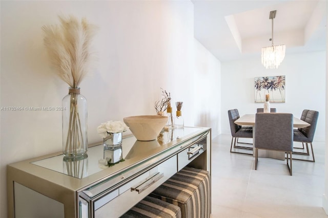 dining room with a chandelier and a tray ceiling