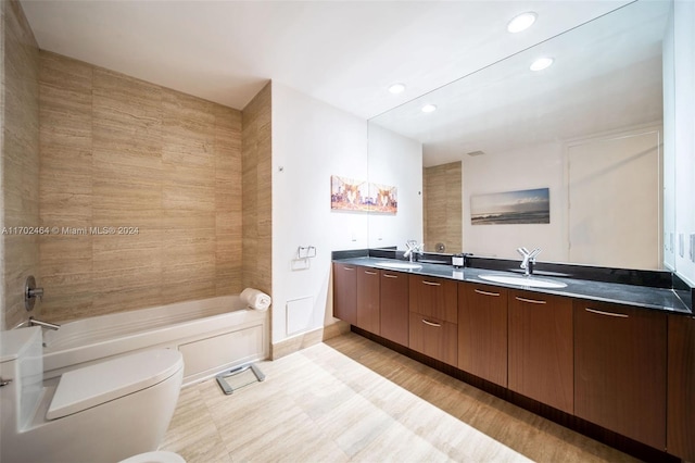 bathroom with vanity, toilet, and a bidet