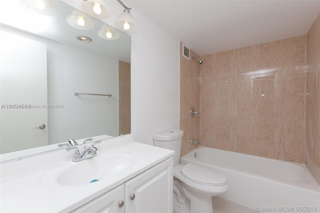 full bathroom featuring vanity, toilet, and tiled shower / bath