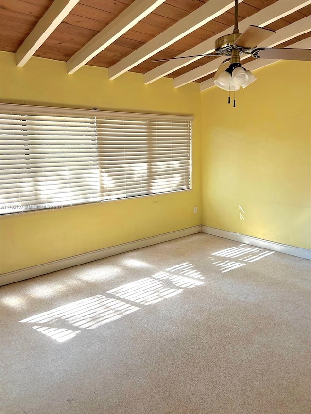 carpeted empty room featuring vaulted ceiling with beams, ceiling fan, and wood ceiling