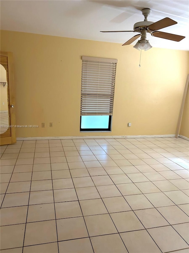 unfurnished room featuring ceiling fan and light tile patterned flooring