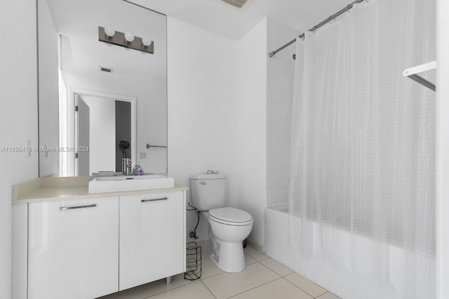 full bathroom featuring tile patterned flooring, vanity, toilet, and shower / bath combo with shower curtain