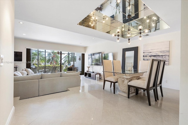 living room with tile patterned floors, a towering ceiling, and an inviting chandelier