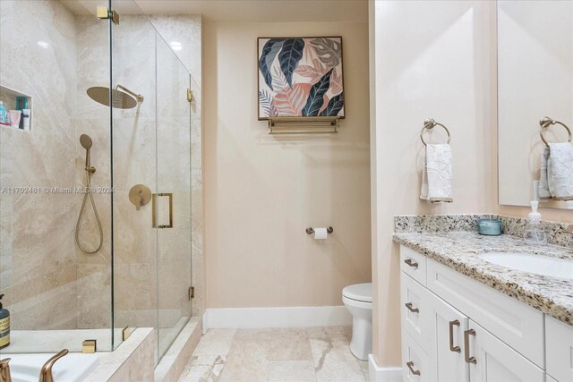 bathroom featuring tile patterned floors, vanity, toilet, and walk in shower