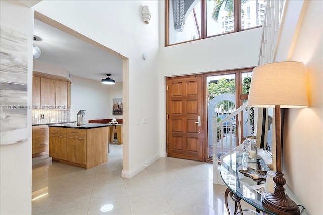 tiled entrance foyer with a high ceiling