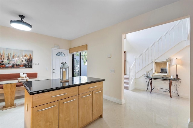 kitchen with a center island and light tile patterned flooring