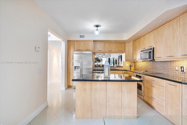 kitchen with stainless steel appliances and light brown cabinetry