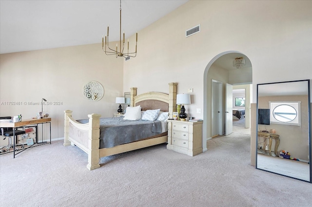 carpeted bedroom with a high ceiling and a notable chandelier