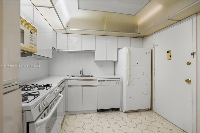 kitchen with sink, white cabinets, and white appliances