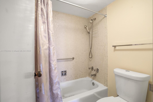 bathroom featuring shower / bath combo and toilet