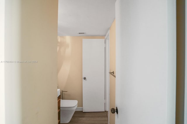 bathroom featuring vanity, toilet, and wood-type flooring