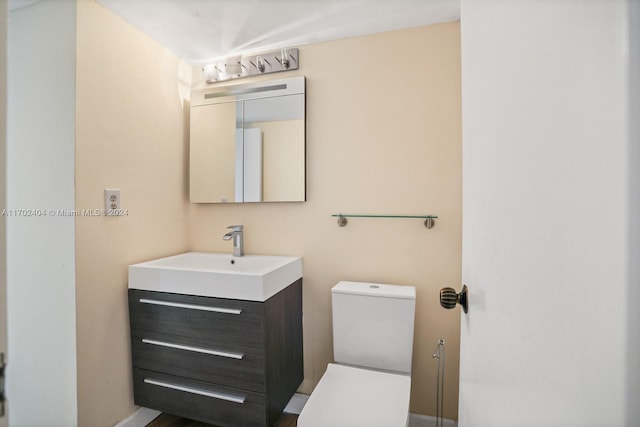 bathroom featuring vanity and toilet