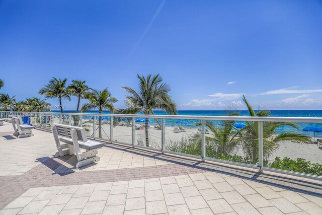 view of patio / terrace featuring a view of the beach and a water view