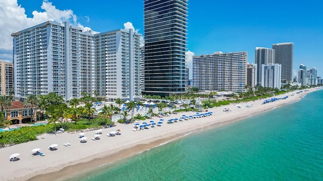 bird's eye view featuring a water view and a beach view