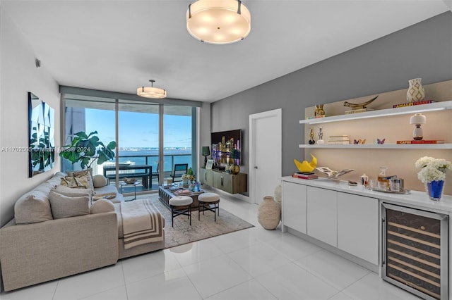 tiled living room featuring bar area and wine cooler