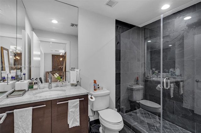 bathroom with vanity, toilet, and a shower with door