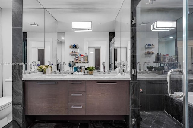 bathroom with vanity, a shower with shower door, and toilet