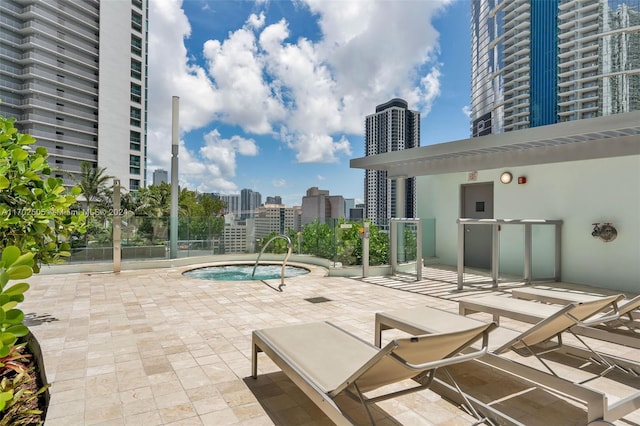 view of swimming pool featuring a hot tub and a patio area