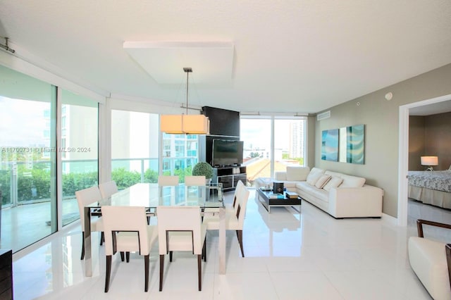 dining room with a wall of windows and light tile patterned flooring