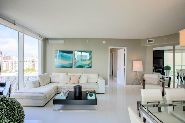 living room with light tile patterned floors and a textured ceiling