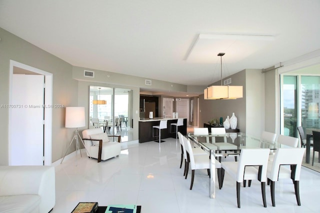 dining space with a healthy amount of sunlight and light tile patterned flooring