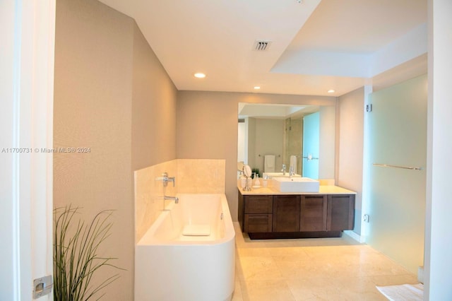 bathroom with a washtub and vanity