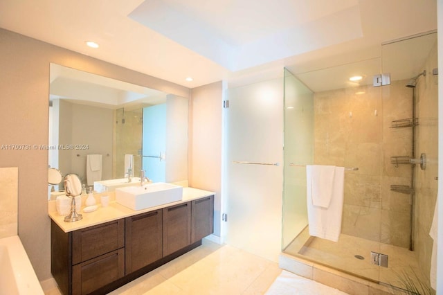 bathroom featuring tile patterned flooring, vanity, a raised ceiling, and a shower with door