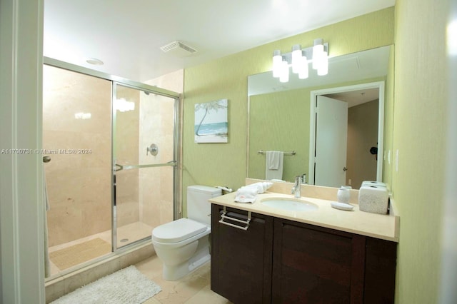 bathroom with vanity, toilet, and a shower with door