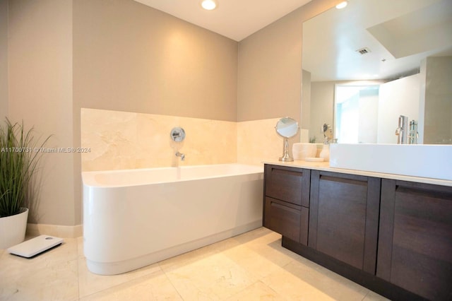 bathroom with a washtub and vanity