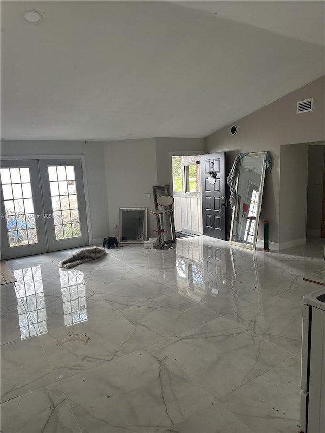 interior space with french doors, vaulted ceiling, and a wealth of natural light