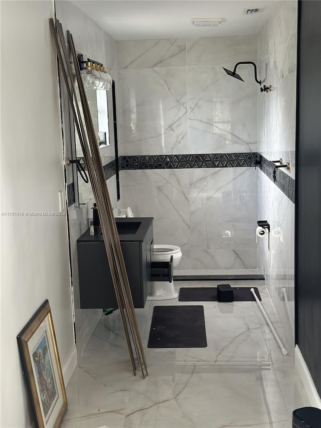 bathroom featuring vanity, toilet, and a tile shower